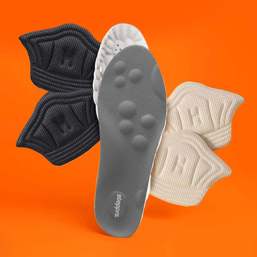 A grey insole and fabric heel cushions floating against an orange backdrop.