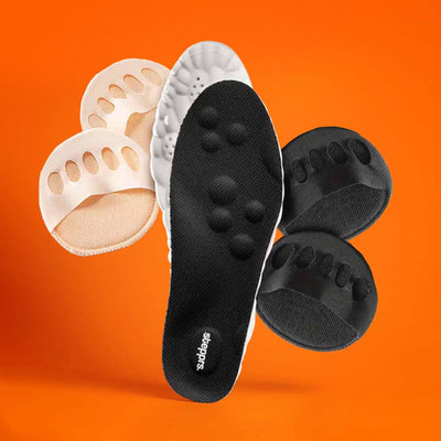 A black insole and fabric toe cushions floating against an orange backdrop.