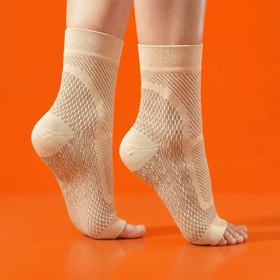 Beige ankle socks worn by a person on an orange background