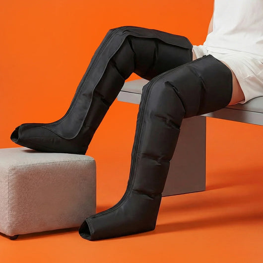 A person wearing the Full Leg Compression Massager while sitting down.